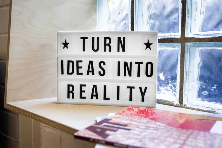 a signboard with the words "Turn Ideas Into Reality" written on it.