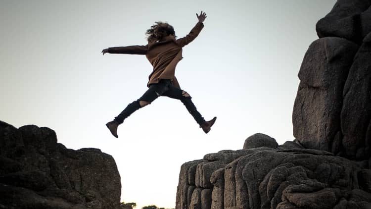 a person leaping over small cliffs.