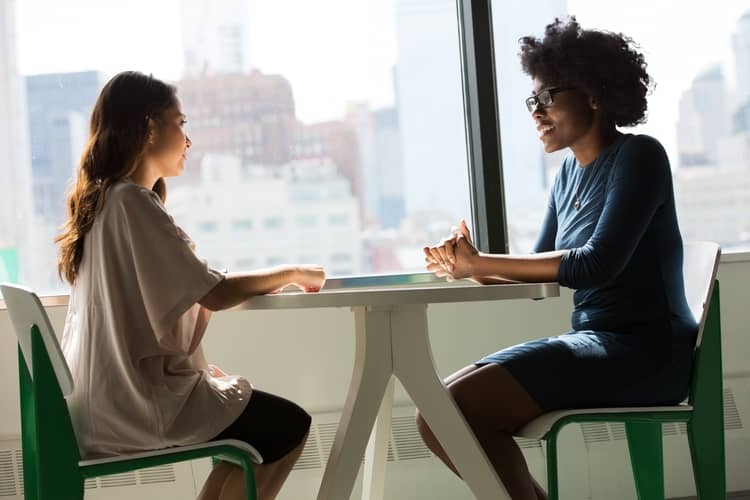 two business professional women talking.