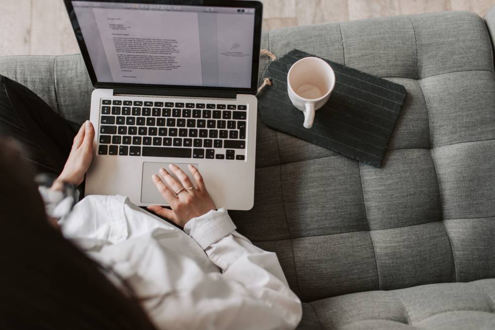 Woman using laptop on sofa