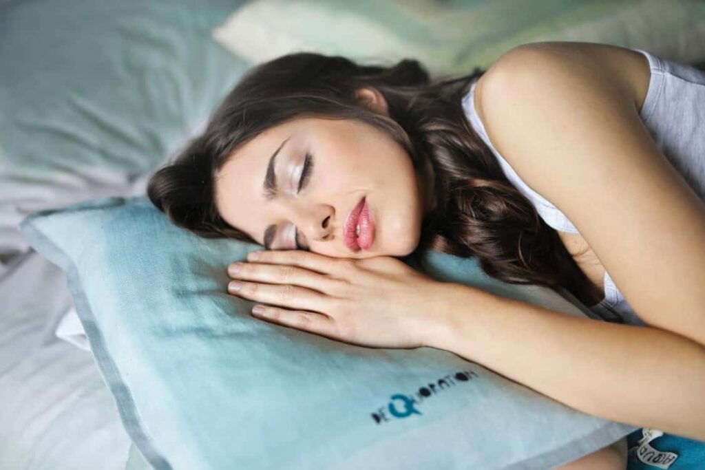 A woman sleeping to represent how important it is to have a good night's sleep before your first day.